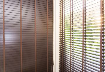 Custom wooden blinds gracing a Malibu home's windows