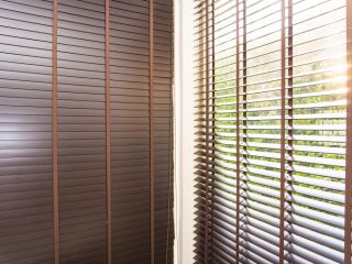 Custom wooden blinds gracing a Malibu home's windows